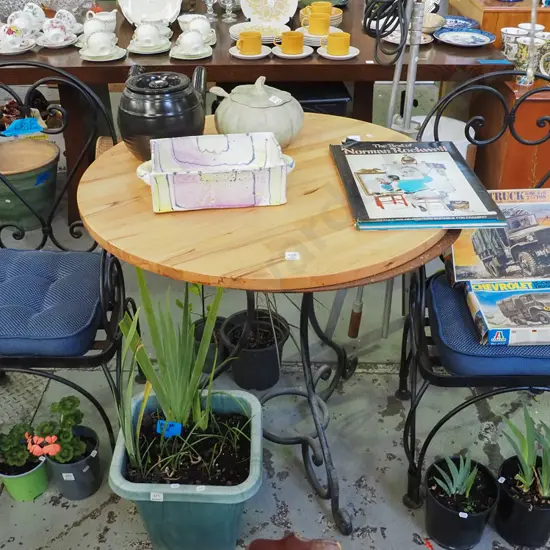 wrought metal based cafe table with 2 matching metal chairs with seat cushions. Table H-780 D-820