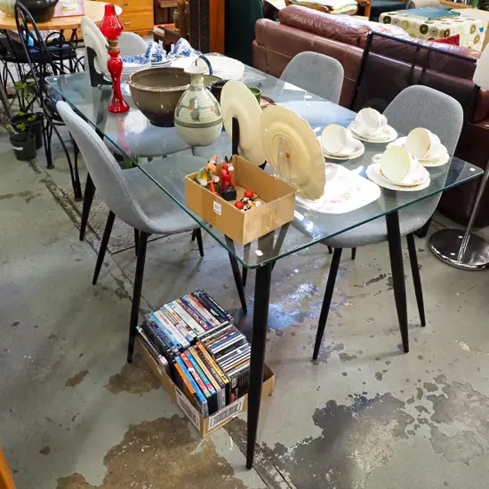 modern glass top table with 4 grey upholstered chairs H-750 W-1400 D-800