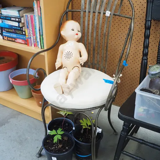 bent metal armchair with cushion