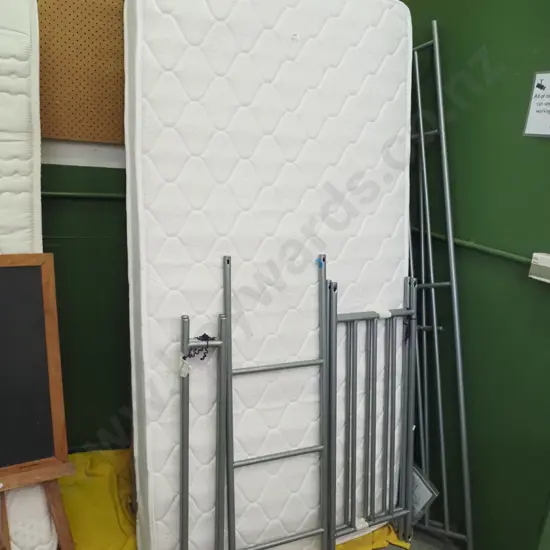 pair of metal based bunk beds with mismatched mattresses