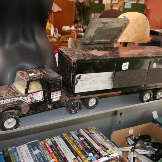 battered and beaten toy truck and trailer unit