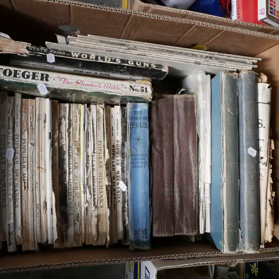 box of vintage books and back issues of Popular Mechanics