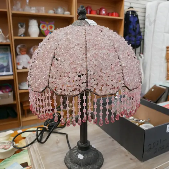 pink plastic tasselled metal based table lamp