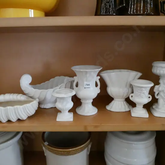 shelf of white vases