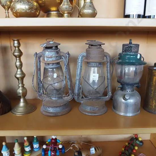 wood and brass candlestick, rusty hurricane lanterns, Tilley lamp, tin