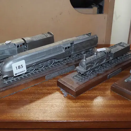 4x die cast model trains on wooden plinths