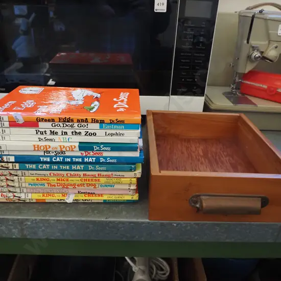 Dr. Seuss books in a small timber drawer with metal handle
