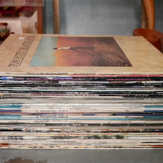 stack of LPs; Tom Petty, Donna Summer etc