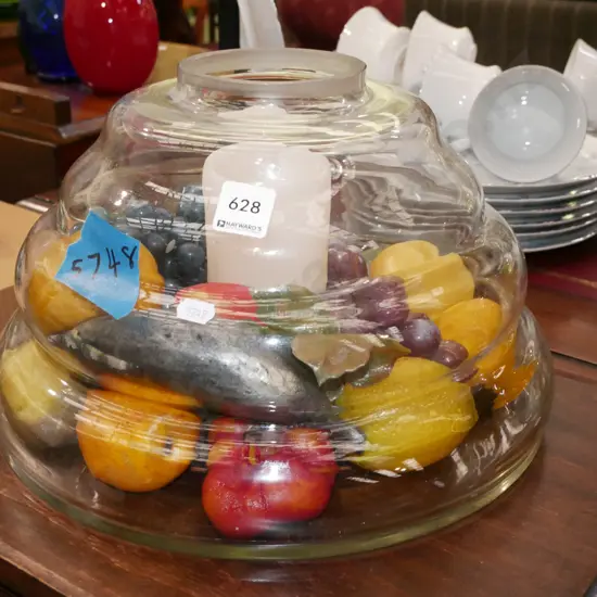 unusual glass vase with faux plastic fruit and candle