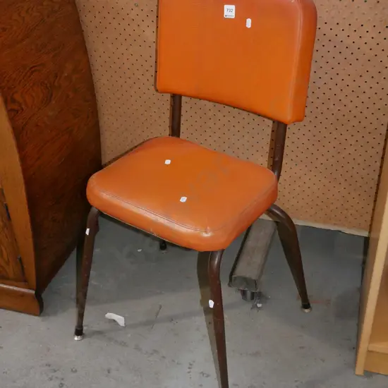orange metal legged chair