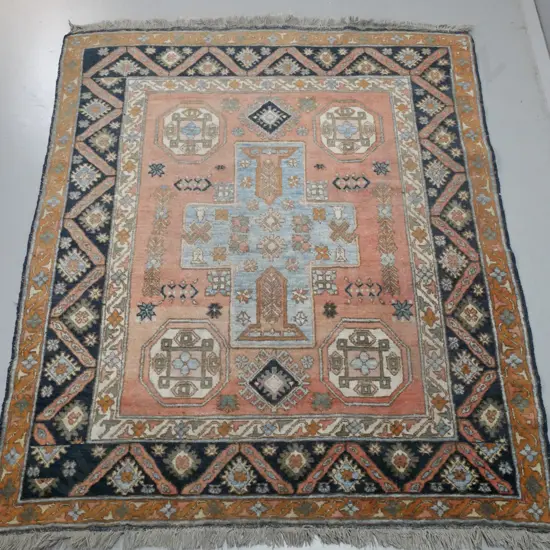 Persian style hand-knotted woollen floor rug - dusty red, blue and brown with black in border - fading and wear. L-1900