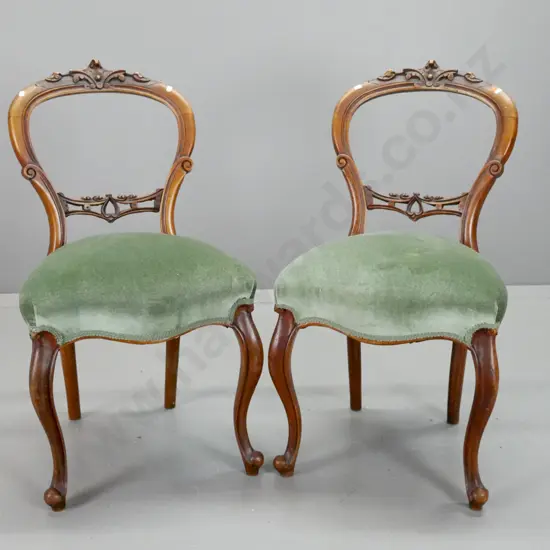 pair of Victorian walnut cab-leg balloon back chairs with carved back splat and crest, green velvet upholstered seat.
