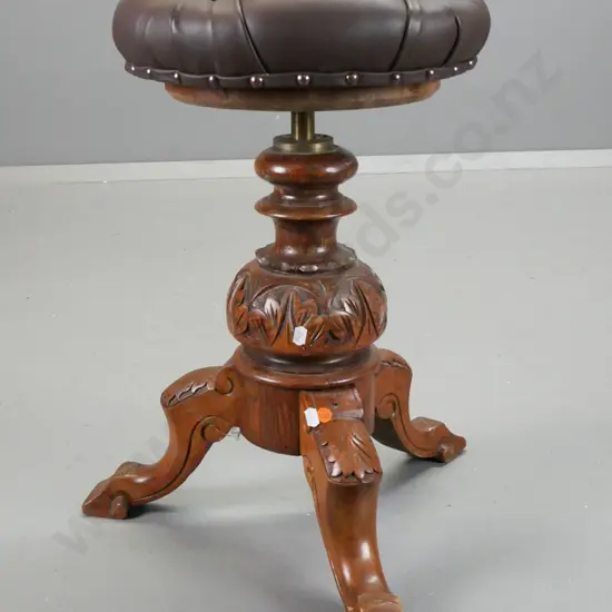 Victorian elm piano stool with revolving height adjustable seat, covered in deep button vinyl, borer holes in seat base