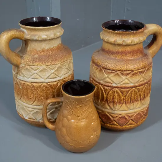 3 moulded relief pattern German pottery vases - pair of jugs H-260 W-160 and a small harvest motif jug