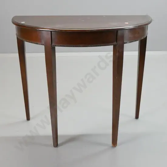 vintage mahogany half-round hall table with 4 square tapered legs, applied decoration to front edge. Scratches and marks