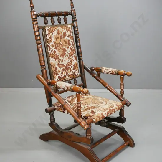 vintage beech Dexter sprung rocker with brown and gold upholstery, arms and seat worn and frayed, some wear to polish on