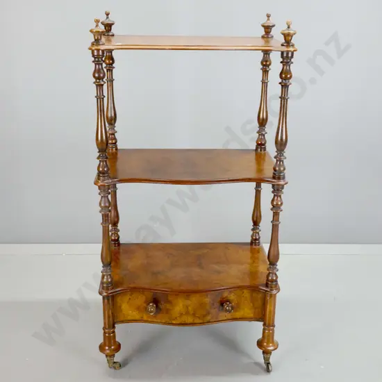 Victorian walnut 3-tier whatnot with turned uprights and finials, shaped bottom drawer with wooden knob, on brass cup