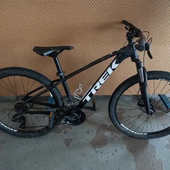 Black and White Trek Marlin bike with silver drink holder