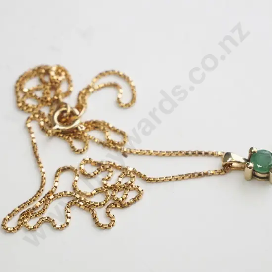 Gold necklace with green round stone pendant