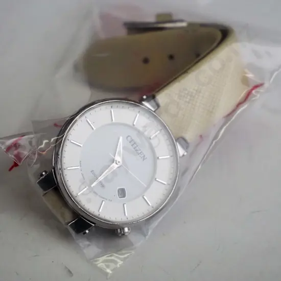 white Citizen watch with cream strap