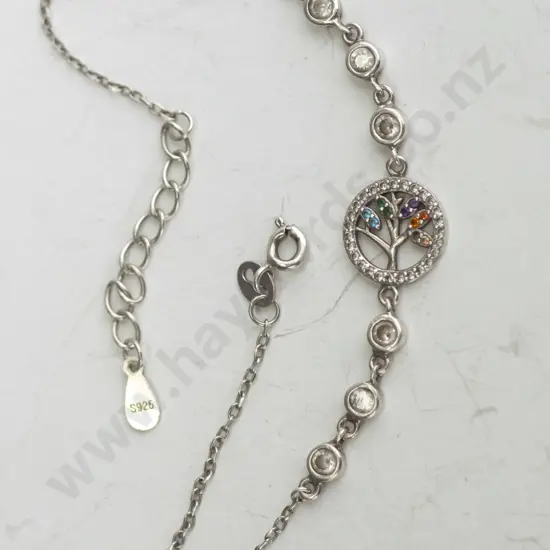 Silver Chain Bracelet with six silver coloured gems and a tree with colorful leaves.