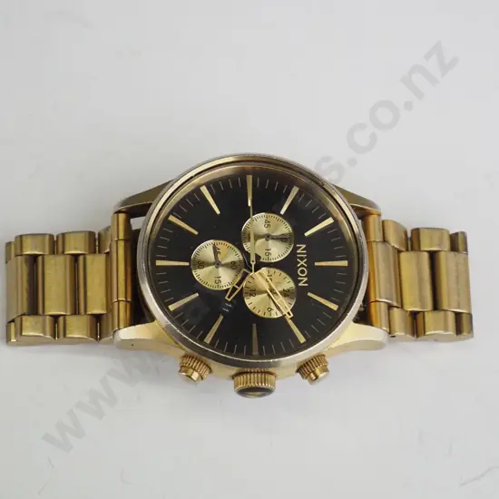 gold Nixon watch 