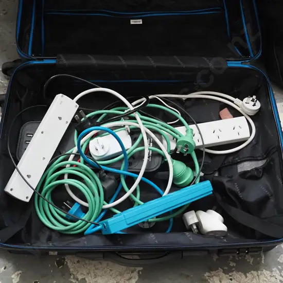 1 suitcase blue in colour  full of extension cords and chargers 