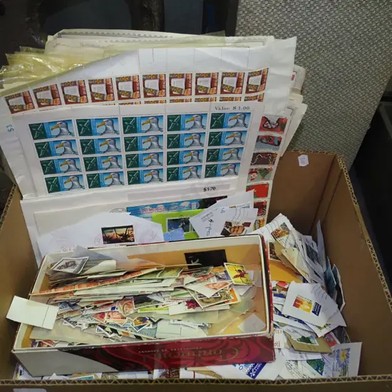 box of loose stamps and stamp albums