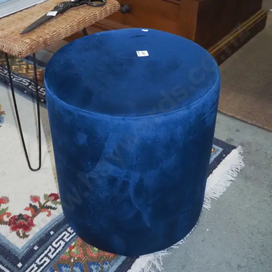 blue upholstered cylindrical ottoman