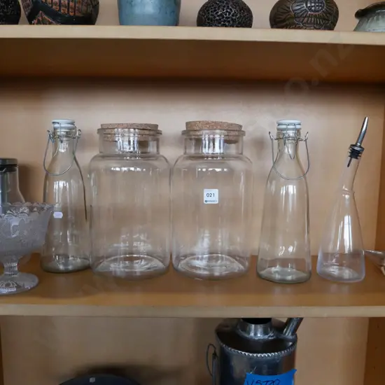 shelf of storage canisters, bottles and a Queen Victoria jubilee glass comport