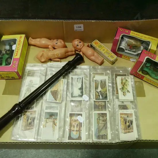 box of model vehicles, cigarette cards, recorder, etc.