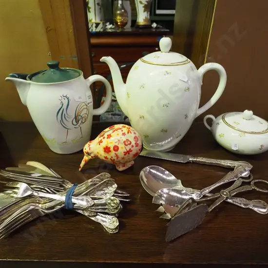 cutlery, coffee pot, sugar and a kiwi themed piggy bank