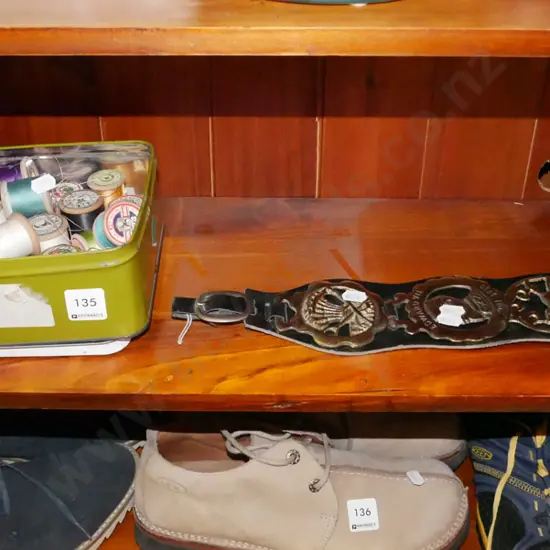 biscuit tin of cotton reels and some horse brasses