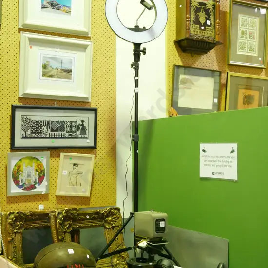 circular  illuminated LED light on stand with cell phone holder