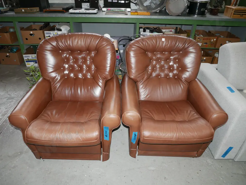 pair of brown leather, deep button upholstered reclining arm chairs, some slight wear to arms Image 1++