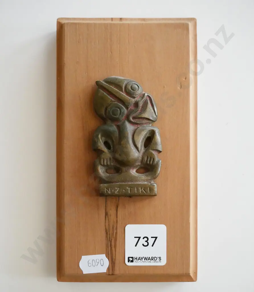 metal tiki on wooden board Image 1++