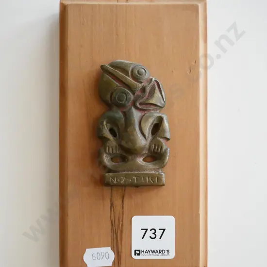 metal tiki on wooden board