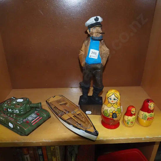 nesting dolls, tin tank, model yacht, sailor figurine