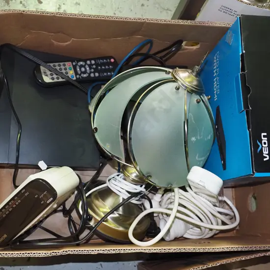 box of extension cord, bedside clock radio, dvd player, table lamp etc.