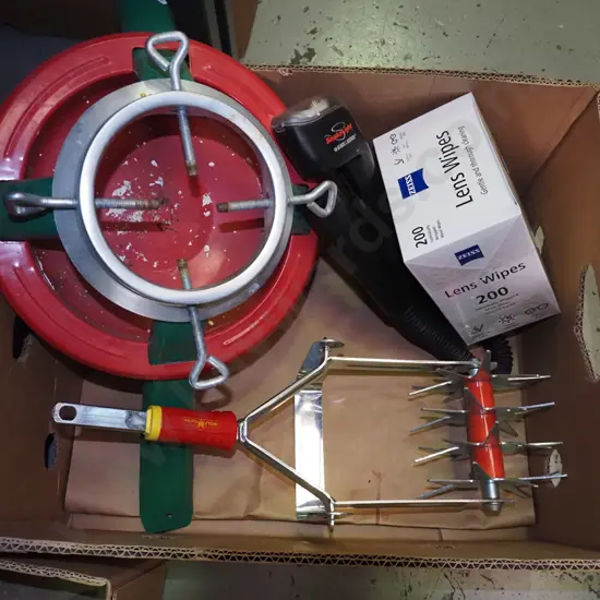 box: Christmas tree stand, lens wipes, part garden cultivator, etc.