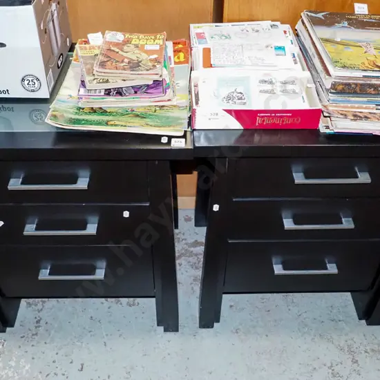 pair of black painted 3 drawer glass top bedside cabintes