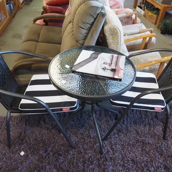 alloy glass top patio table with 2 matching chairs and cushions - very good condition