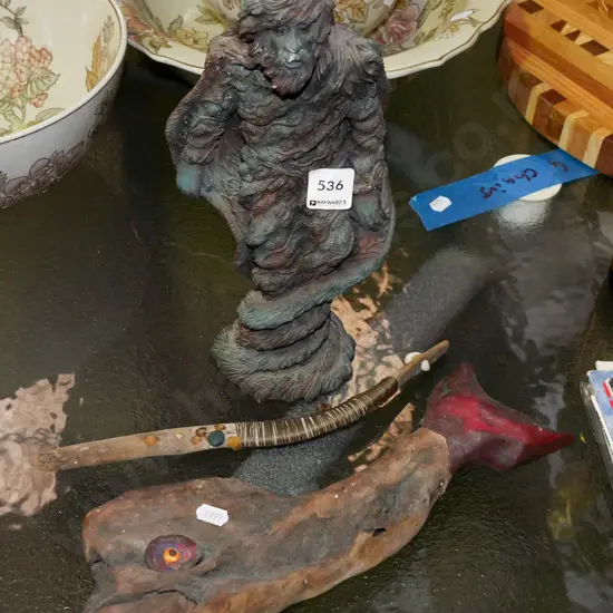 composite green man figurine, driftwood whale and stick