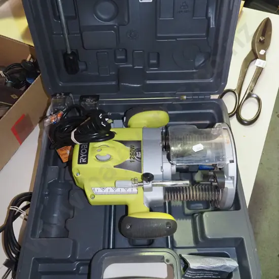 cased Ryobi 1250W plunge router with bits