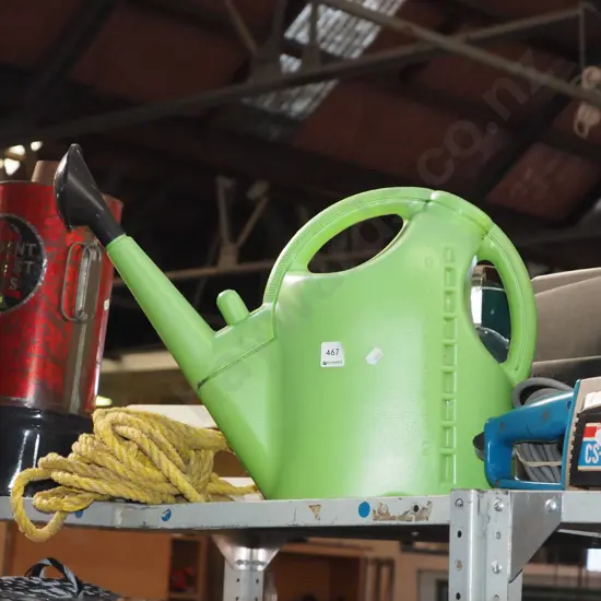 green plastic watering can