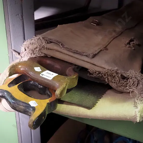 assorted hand saws in canvas carry bag