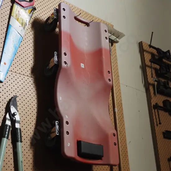 red plastic creeper trolley