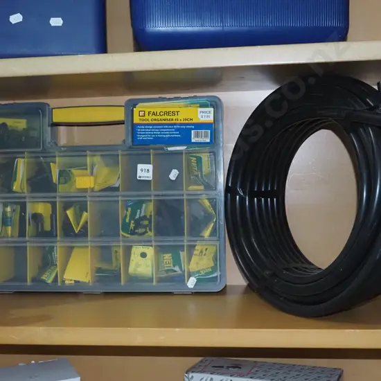 plastic organiser with Netta irrigation supplies, roll of plastic irrigation pipe