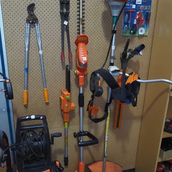 Ozito battery powered multi tool with hedge trimmers and chainsaw attachments