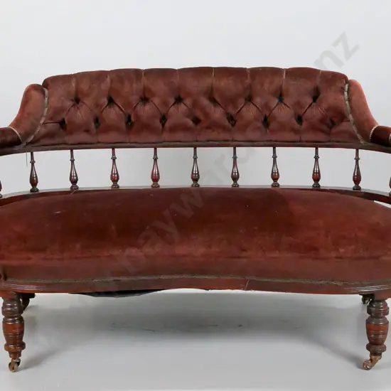 restorer's Edwardian tub couch with turned spindle back, deep button back, porcelain casters. Old repairs to back, loose